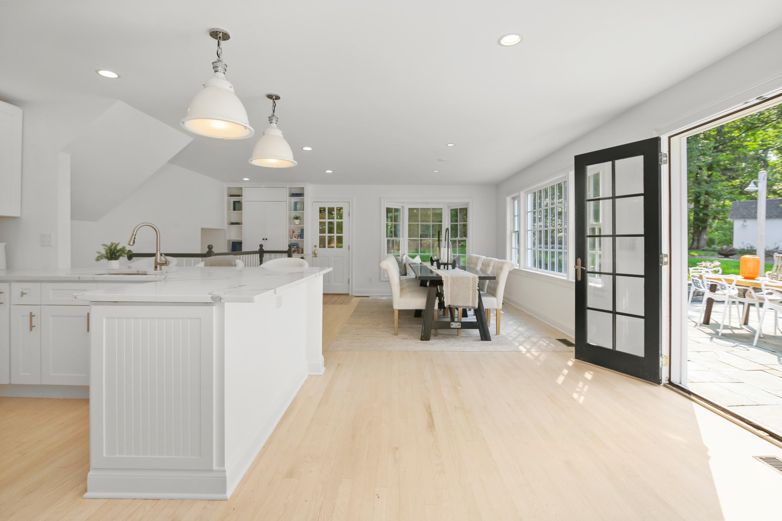 114 Colony Road Darien, CT 06820 - Photo 7 of 40 a large white kitchen with a large window and chairs