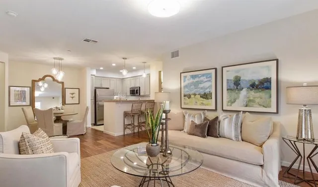 a living room with furniture and a chandelier