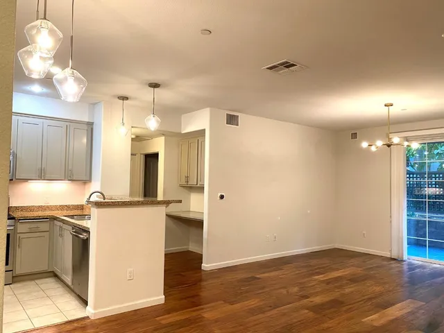 a view of a kitchen with a sink and a refrigerator