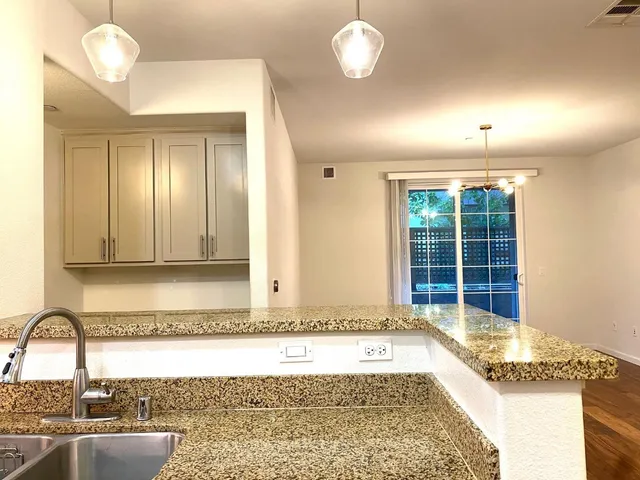 a view of a kitchen with a stove and bathtub