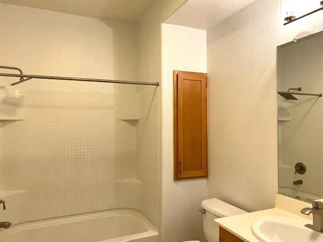 a bathroom with a shower curtain and a sink