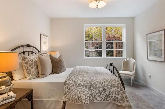 a bedroom with furniture and a window