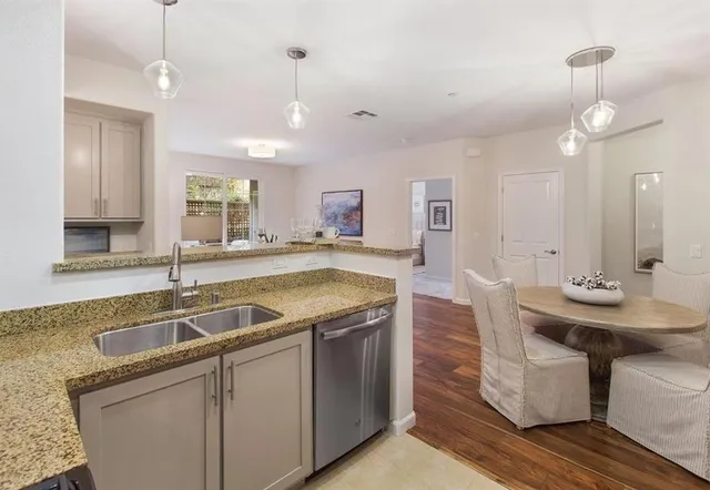 a kitchen with sink stove and refrigerator