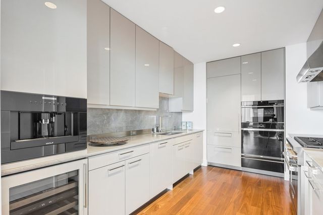 a kitchen with a sink stainless steel appliances and cabinets