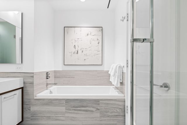 a bathroom with a bathtub and a shower