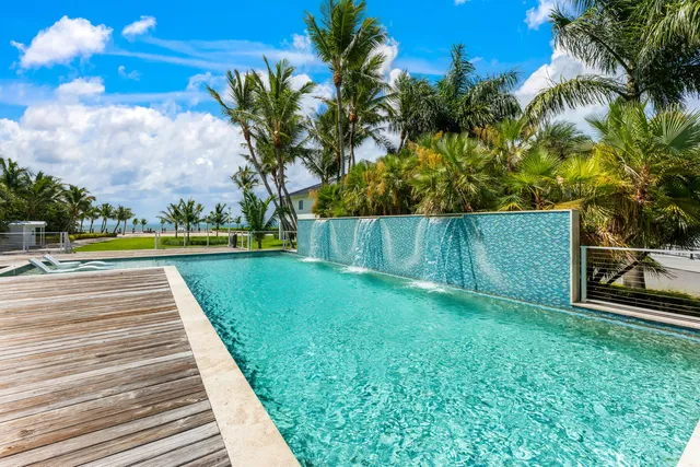 a kitchen with stainless steel appliances kitchen island granite countertop a sink and stove