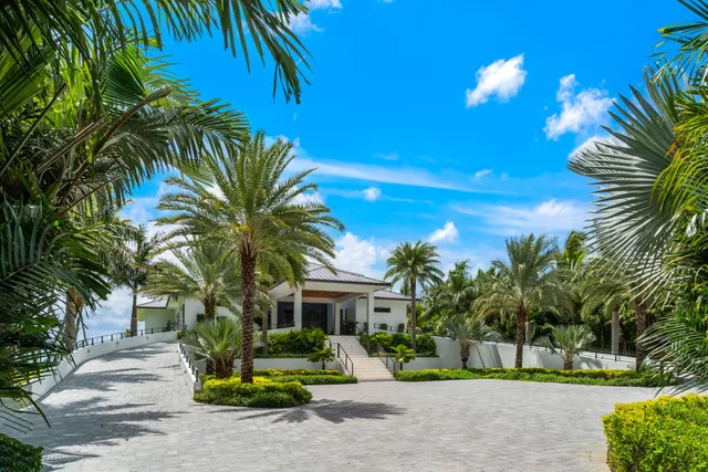 a living room with patio furniture and a floor to ceiling window