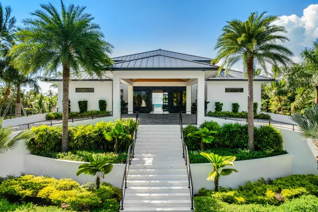 a front view of house with a garden and swimming pool