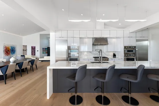 a bedroom with two large bed and a large window