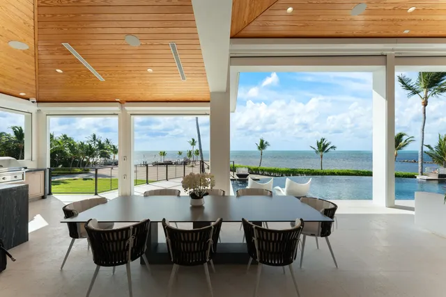 a bedroom with a large window and a balcony
