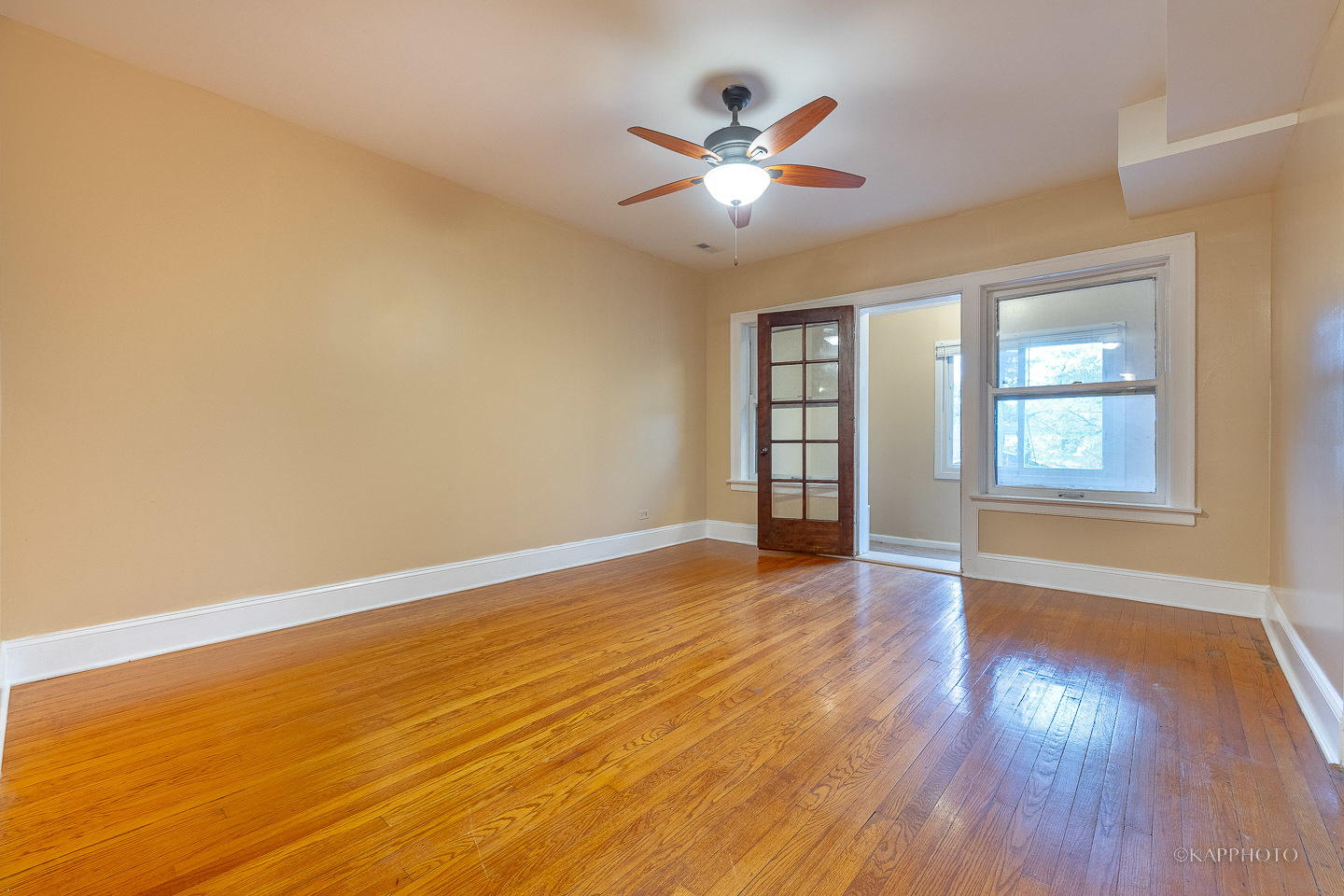 6819 South Ridgeland Avenue, Unit 2 Chicago, IL 60649 - Photo 13 of 27 a view of an empty room with wooden floor and a window