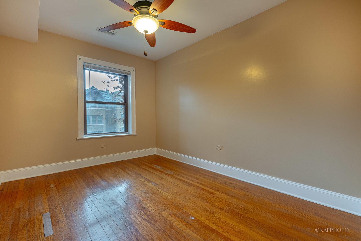 6819 South Ridgeland Avenue, Unit 2 Chicago, IL 60649 - Photo 14 of 27 a view of an empty room with wooden floor and a window