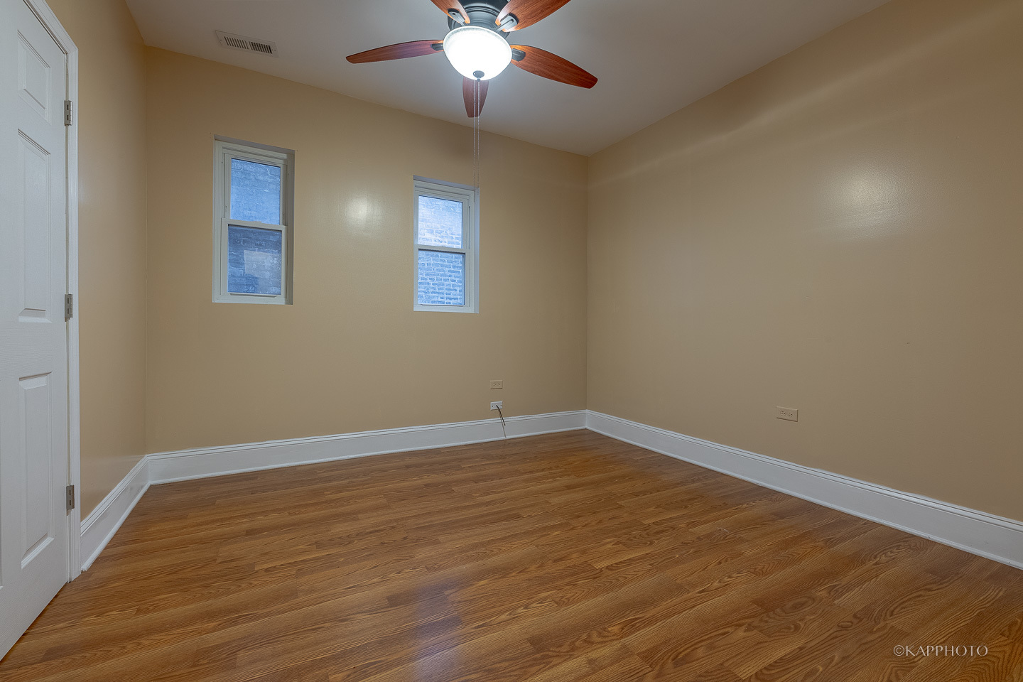 6819 South Ridgeland Avenue, Unit 2 Chicago, IL 60649 - Photo 16 of 27 a view of an empty room with wooden floor and a window
