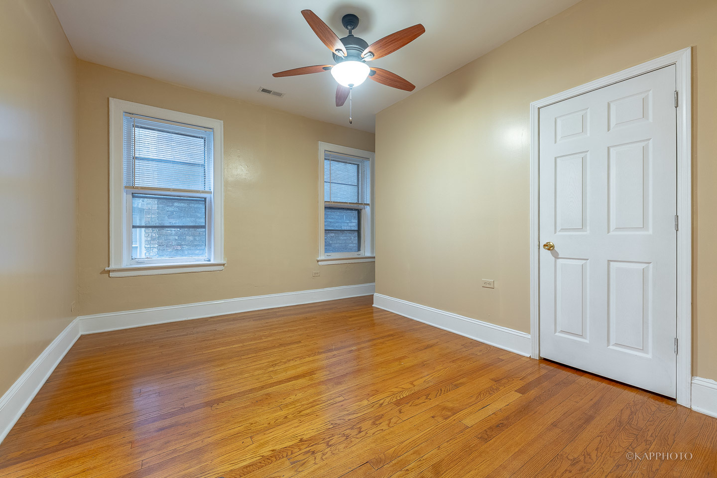6819 South Ridgeland Avenue, Unit 2 Chicago, IL 60649 - Photo 19 of 27 a view of an empty room with window and wooden floor