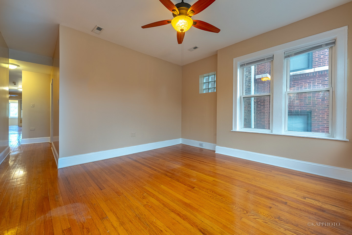 6819 South Ridgeland Avenue, Unit 2 Chicago, IL 60649 - Photo 3 of 27 a view of an empty room with window and wooden floor