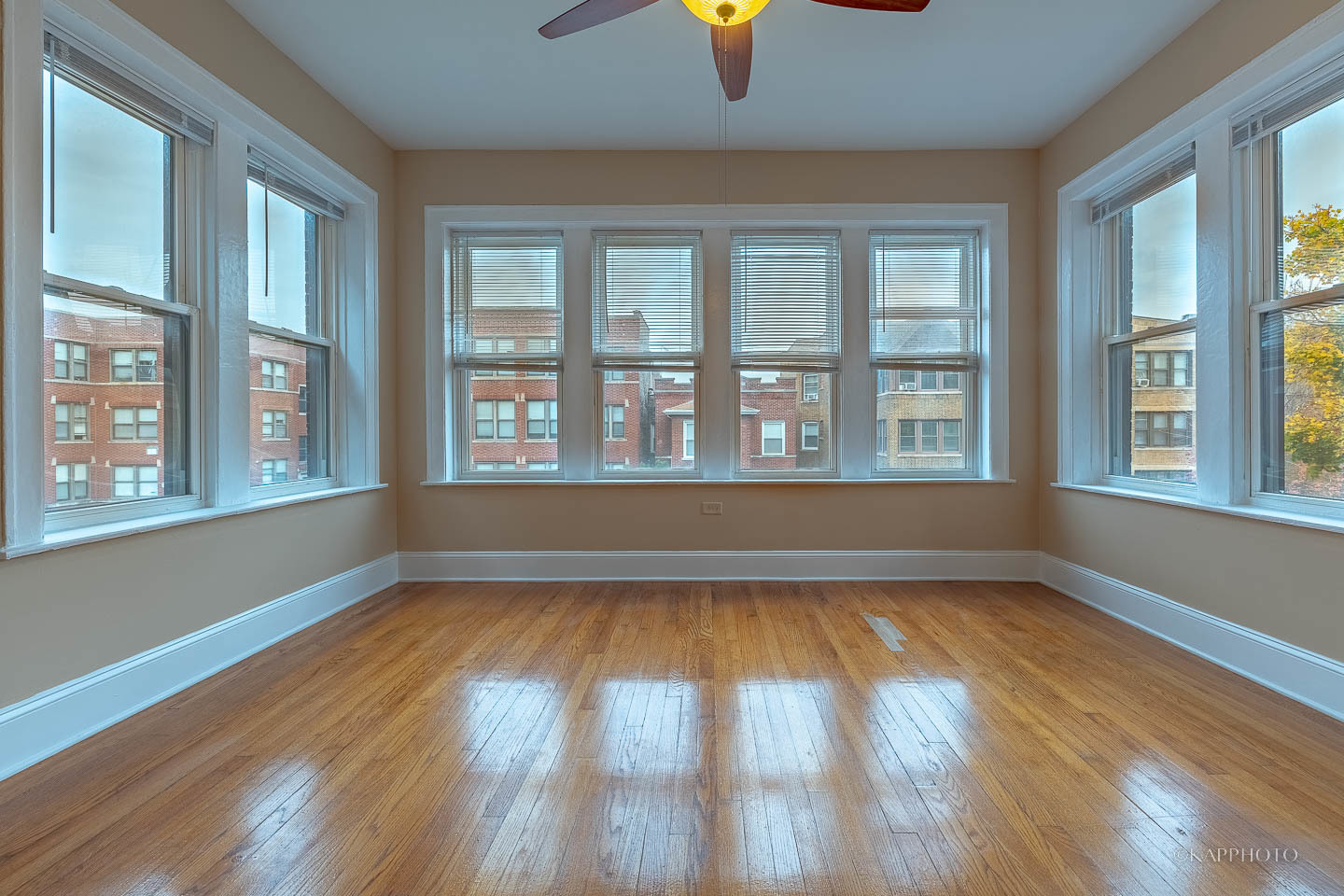6819 South Ridgeland Avenue, Unit 2 Chicago, IL 60649 - Photo 4 of 27 a view of an empty room with wooden floor and a window