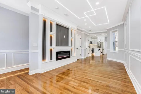 front view of a brick house with a yard