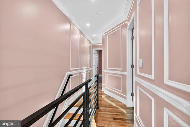 wooden floor fireplace and windows in an empty room
