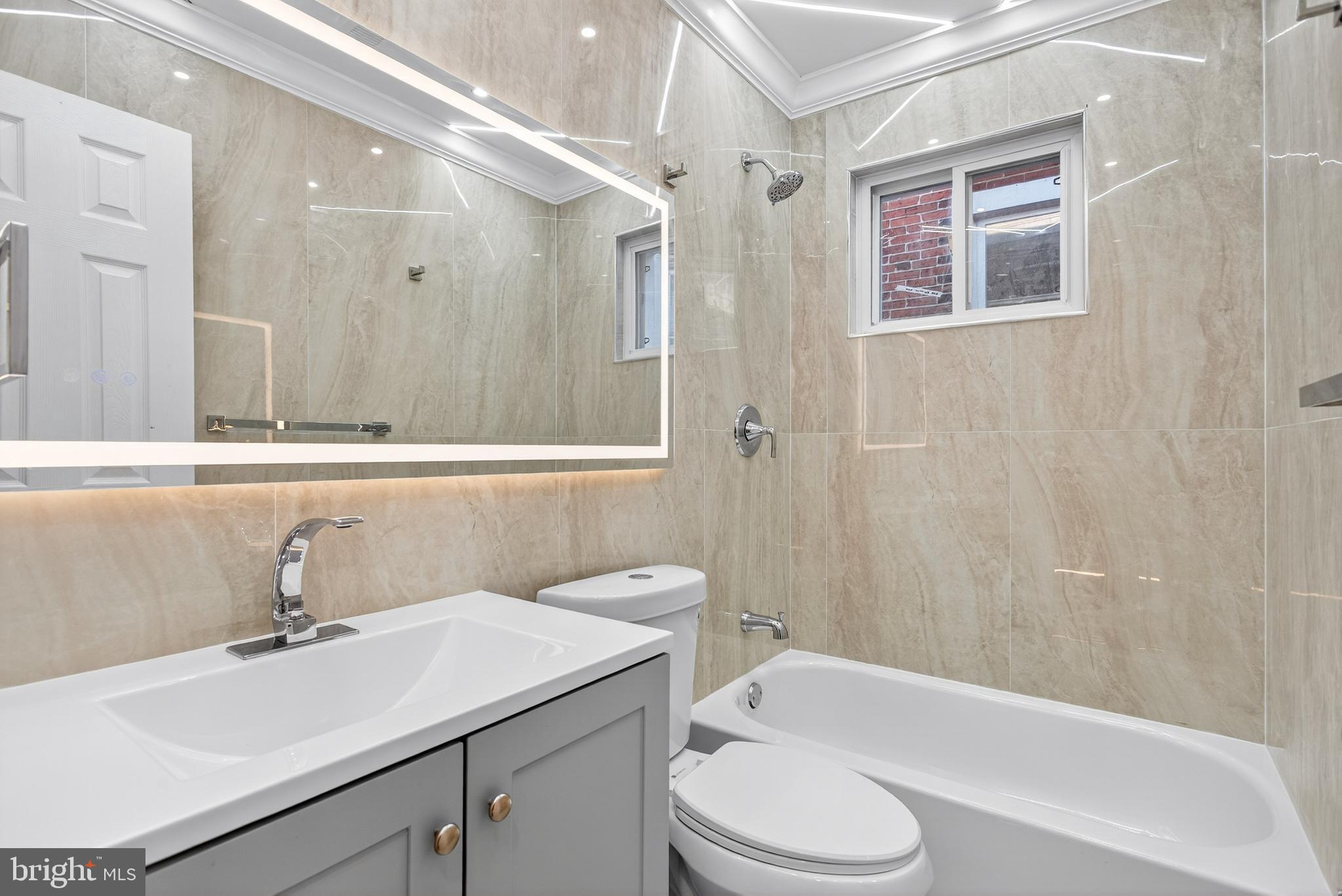 5421 Kingsessing Avenue Philadelphia, PA 19143 - Photo 29 of 39 a bathroom with a sink a toilet and shower