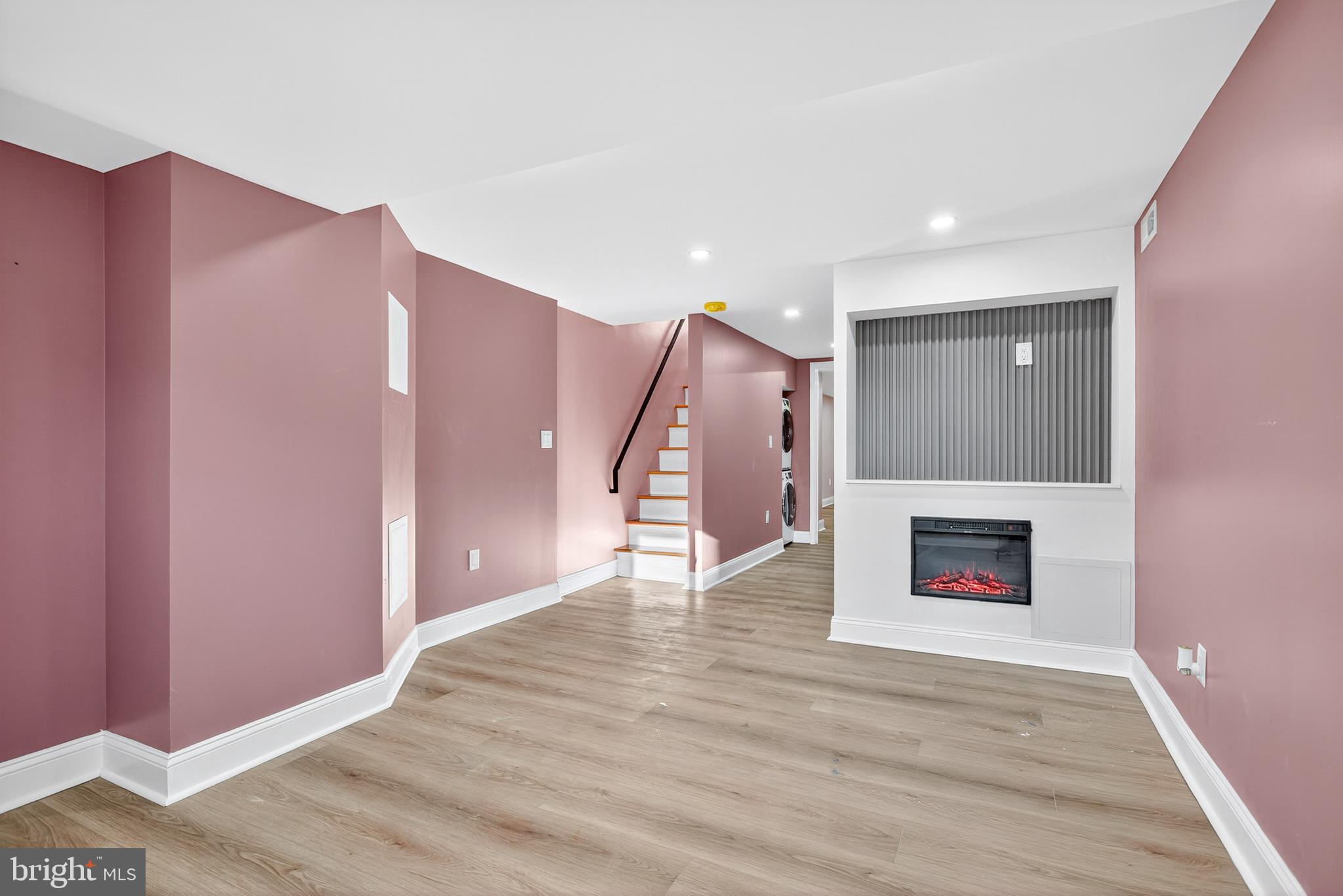 5421 Kingsessing Avenue Philadelphia, PA 19143 - Photo 30 of 39 a view of an empty room with wooden floor and a fireplace