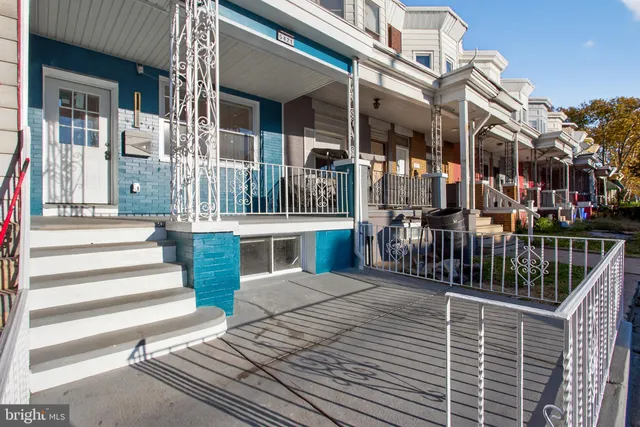 front view of a brick house with a yard