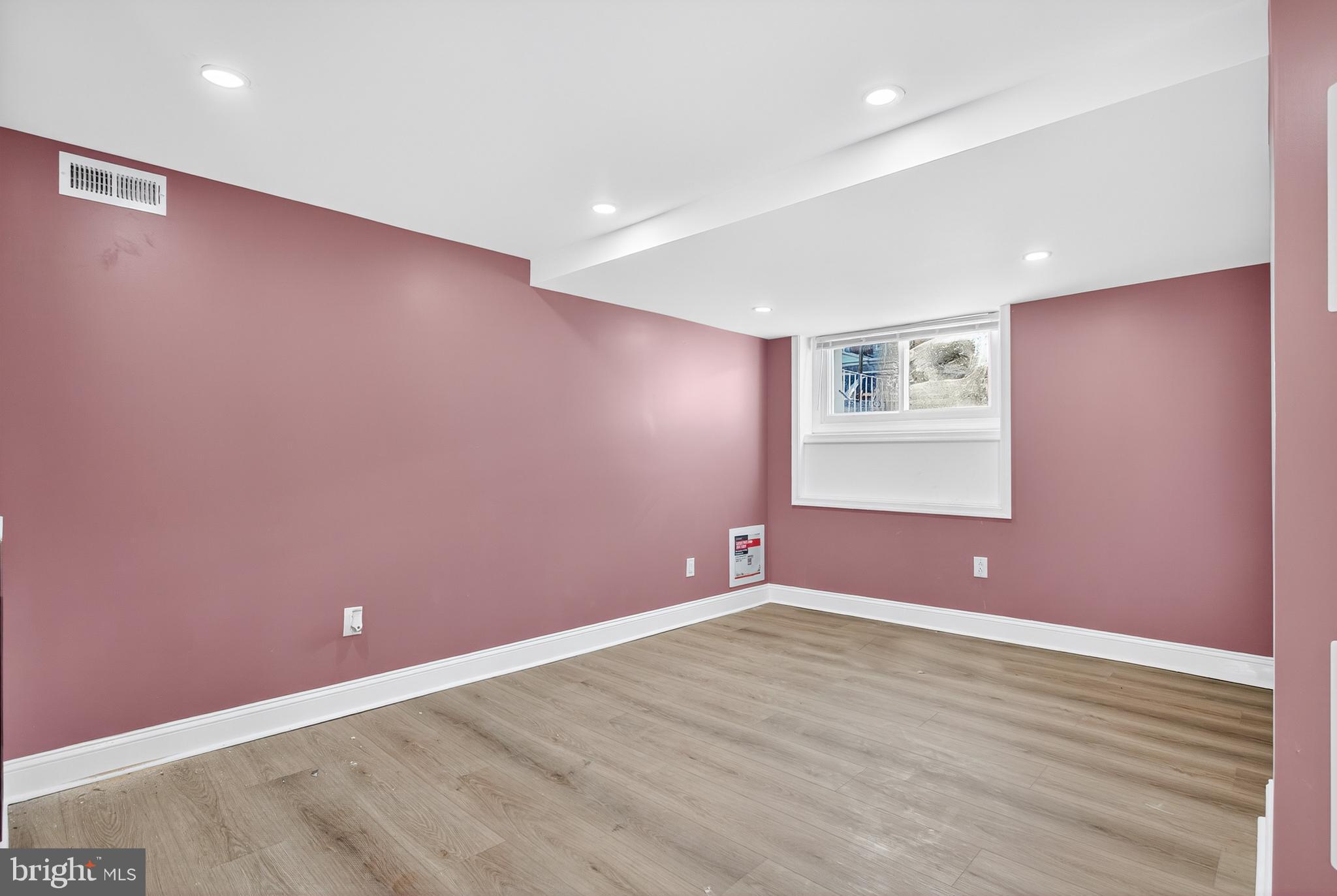 5421 Kingsessing Avenue Philadelphia, PA 19143 - Photo 33 of 39 an empty room with wooden floor and windows