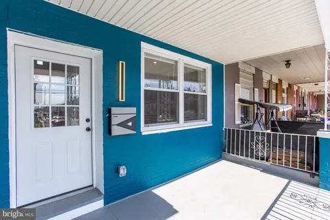 a view of a patio with couches and potted plants