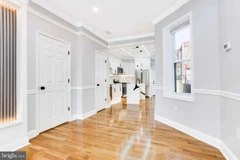 a view of a street with a wooden fence