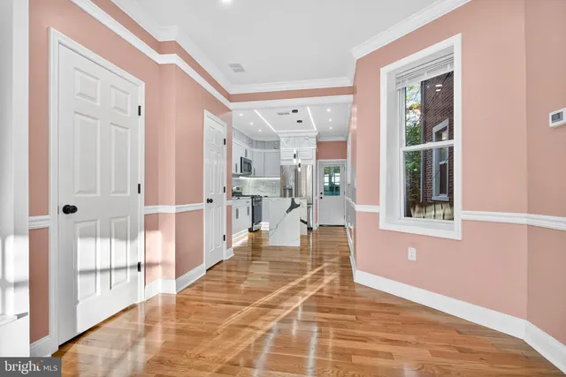 a kitchen with kitchen island granite countertop a stove and a microwave