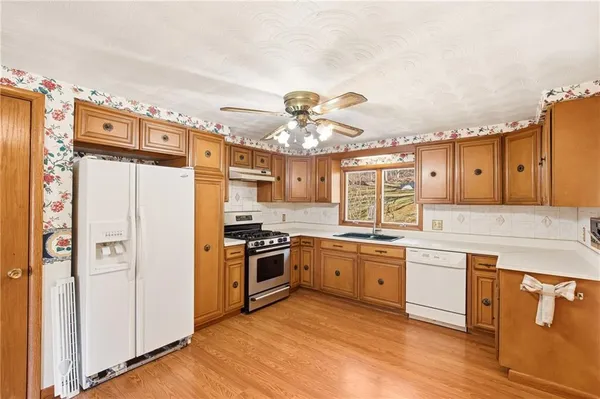 a kitchen with a sink stove and refrigerator