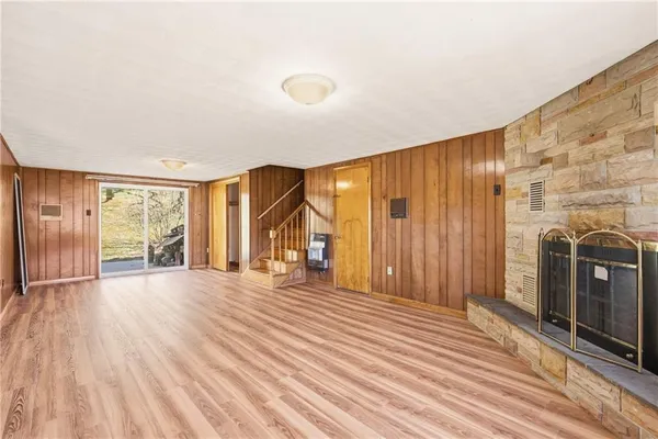a view of an entryway with wooden floor and door
