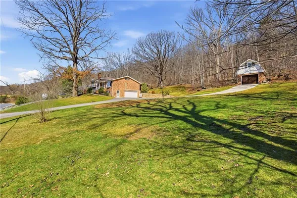 a view of yard with swimming pool and green space