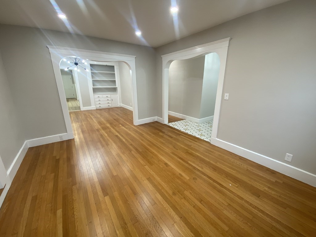 74 Wallingford Road, Unit 1 Boston, MA 02135 - Photo 1 of 1 a view of empty room with wooden floor