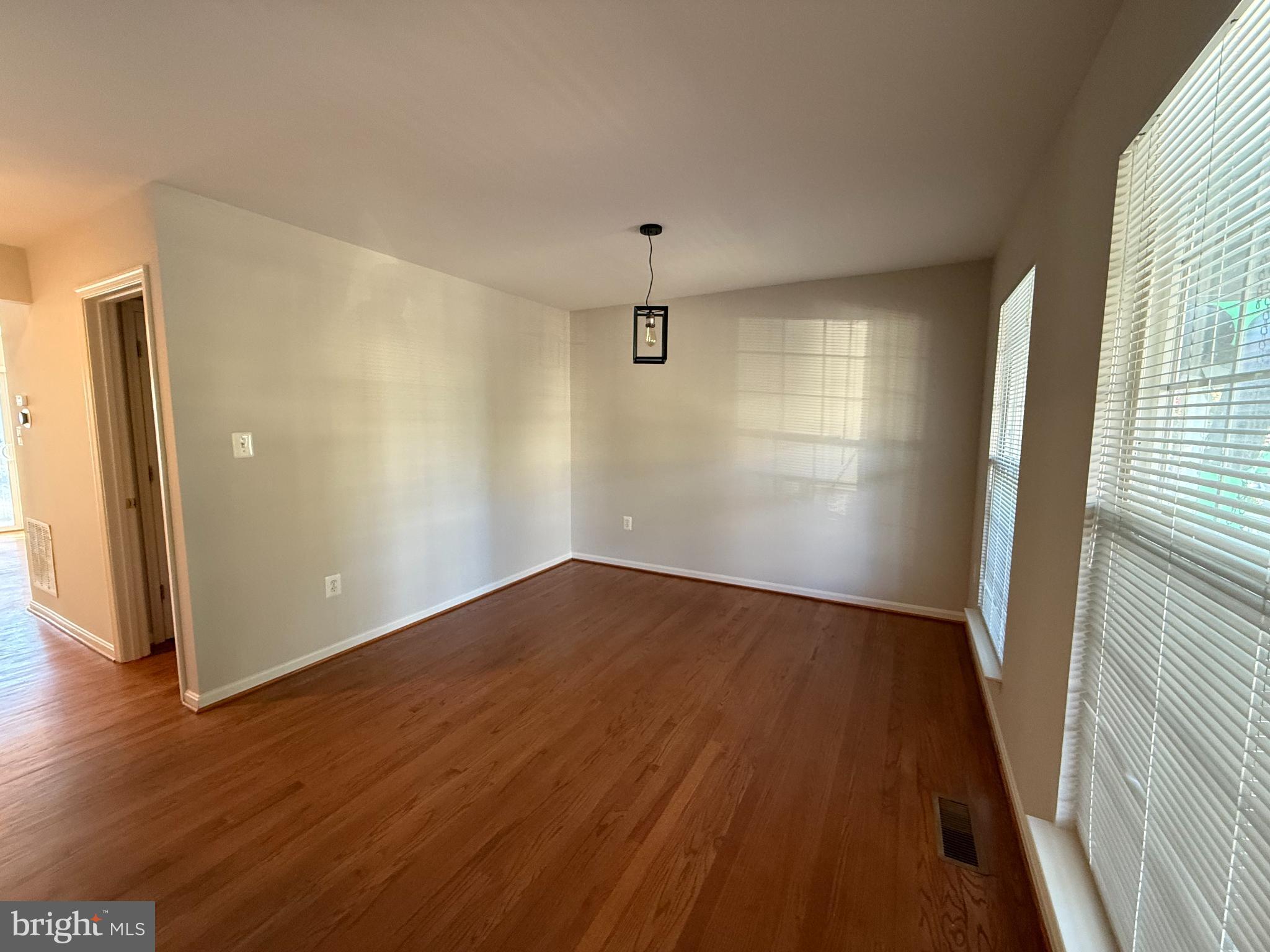 20453 Charter Oak Drive Ashburn, VA 20147 - Photo 14 of 31 an empty room with wooden floor and windows