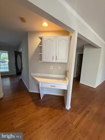 a view of an entryway with wooden floor
