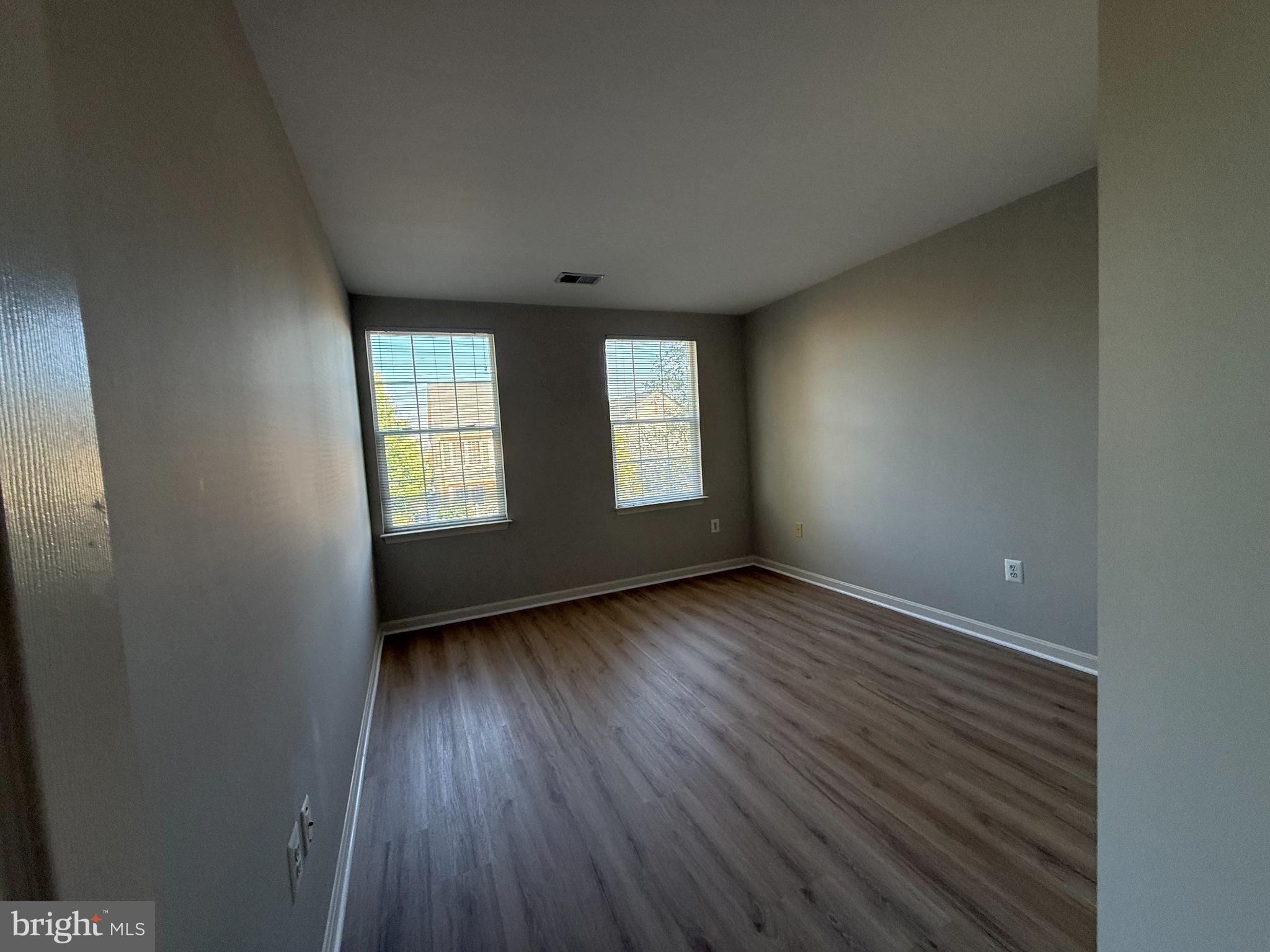20453 Charter Oak Drive Ashburn, VA 20147 - Photo 31 of 31 an empty room with wooden floor and windows
