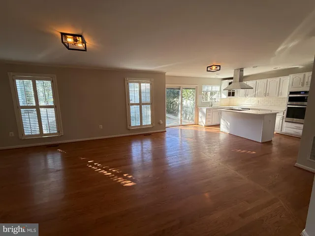 a view of a living room and kitchen with a large window