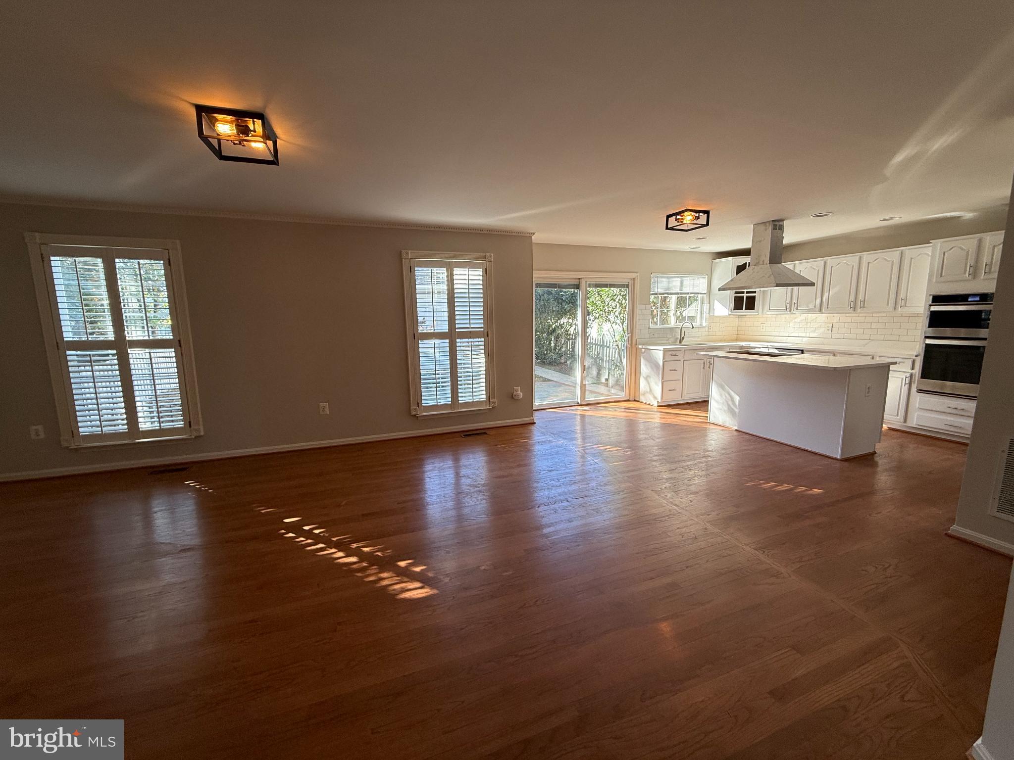 20453 Charter Oak Drive Ashburn, VA 20147 - Photo 4 of 31 a view of a living room and kitchen with a large window