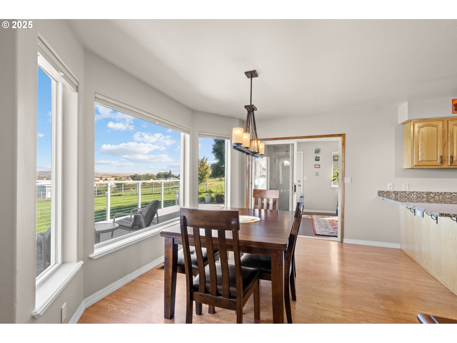 75077 Oregon Lane Irrigon, OR 97844 - Photo 11 of 41 a view of a dining room and livingroom with furniture wooden floor a chandelier