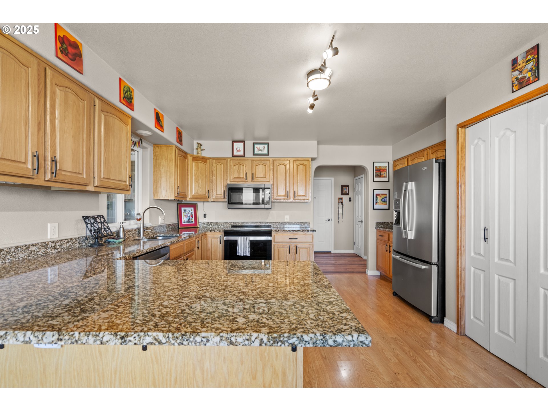 75077 Oregon Lane Irrigon, OR 97844 - Photo 7 of 41 a kitchen with kitchen island granite countertop a refrigerator stove microwave and sink