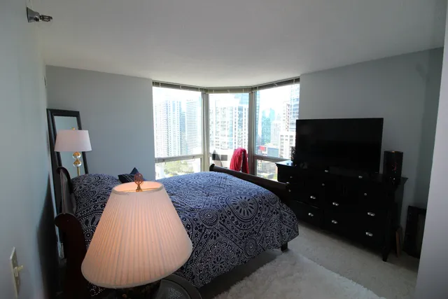 a bed room with a bed window and a chair