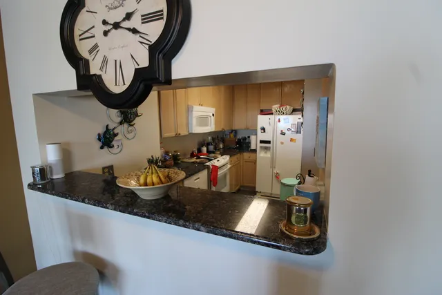 a kitchen with a sink and a chandelier
