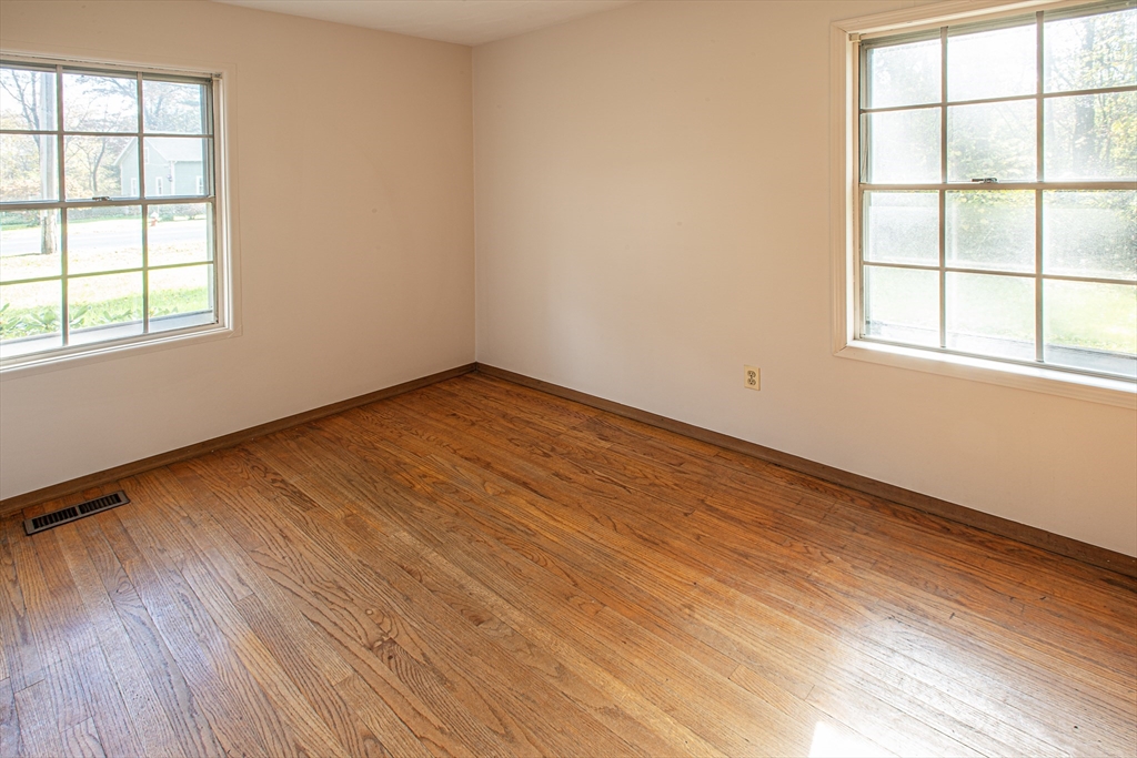 21 Dwight Street Hatfield, MA 01038 - Photo 17 of 24 an empty room with wooden floor and windows