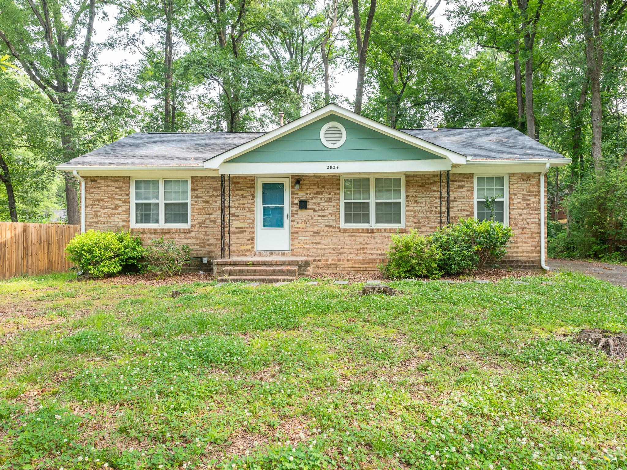 2824 Fordwood Drive Charlotte, NC 28208 - Photo 1 of 33 a front view of a house with a yard