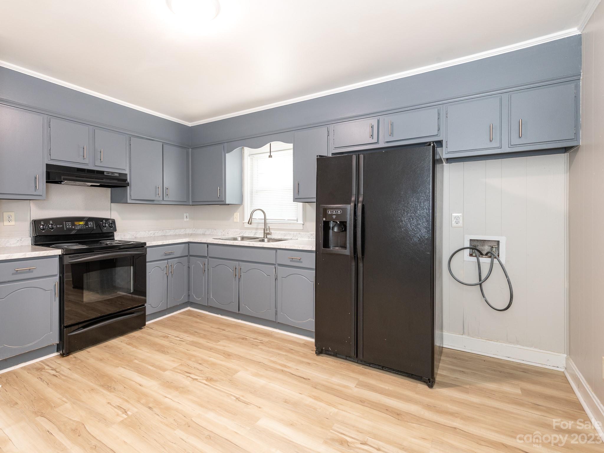 2824 Fordwood Drive Charlotte, NC 28208 - Photo 14 of 33 a kitchen with a refrigerator and a sink