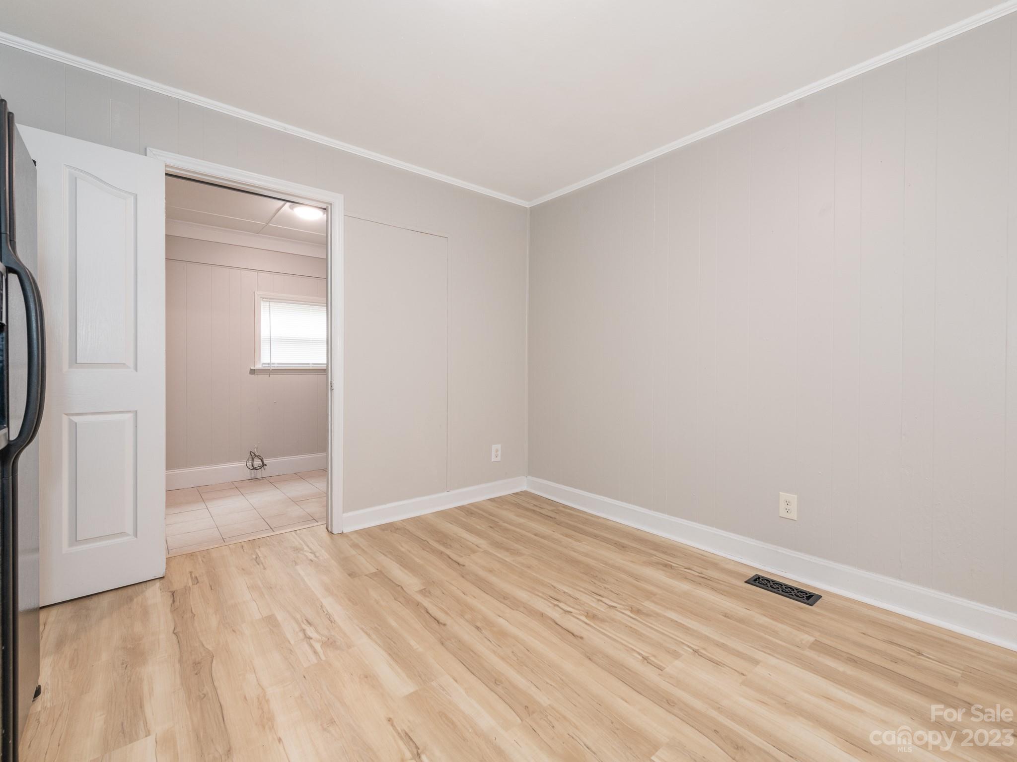 2824 Fordwood Drive Charlotte, NC 28208 - Photo 16 of 33 a view of an empty room with wooden floor and a window