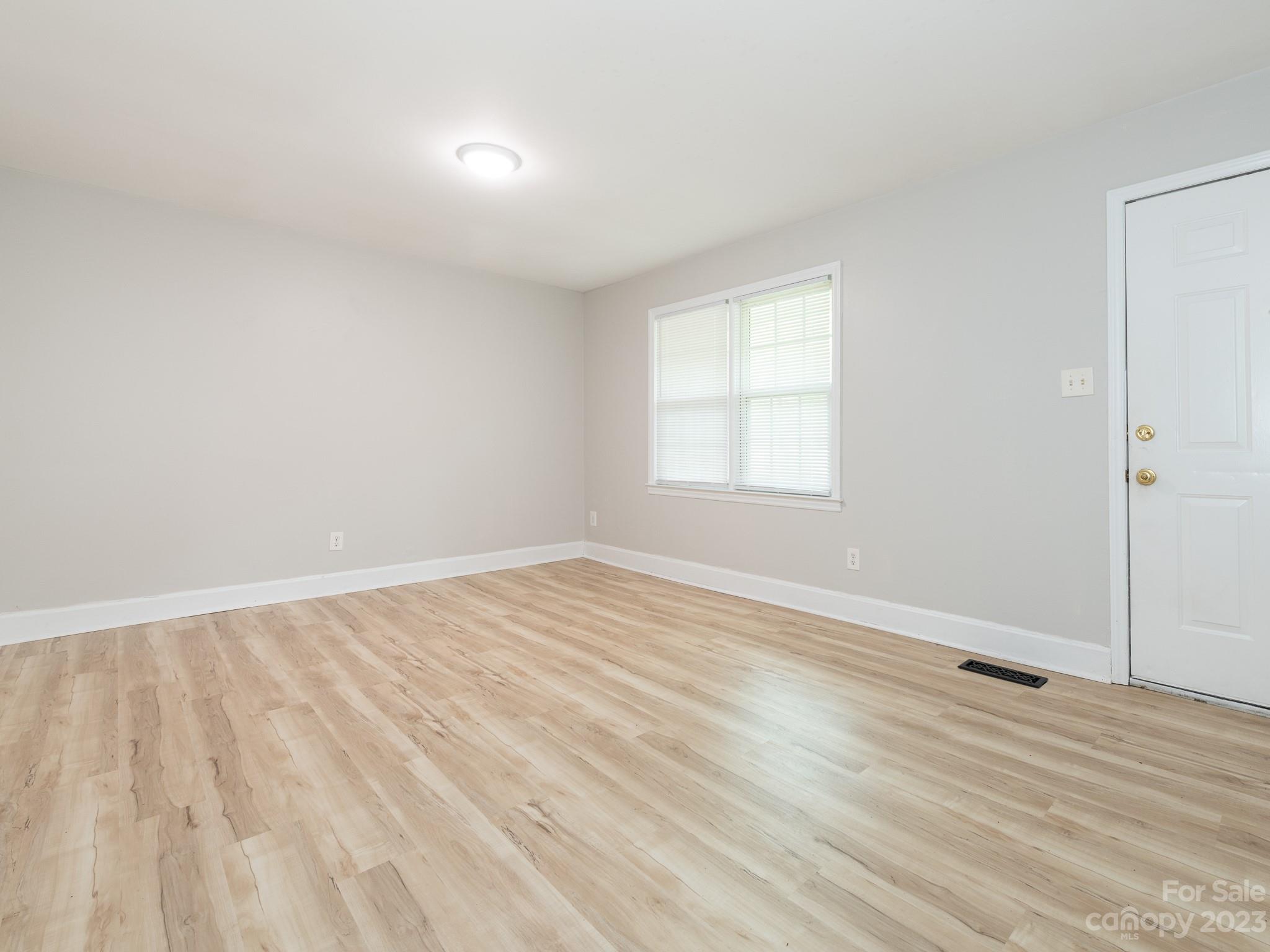 2824 Fordwood Drive Charlotte, NC 28208 - Photo 2 of 33 an empty room with wooden floor and windows