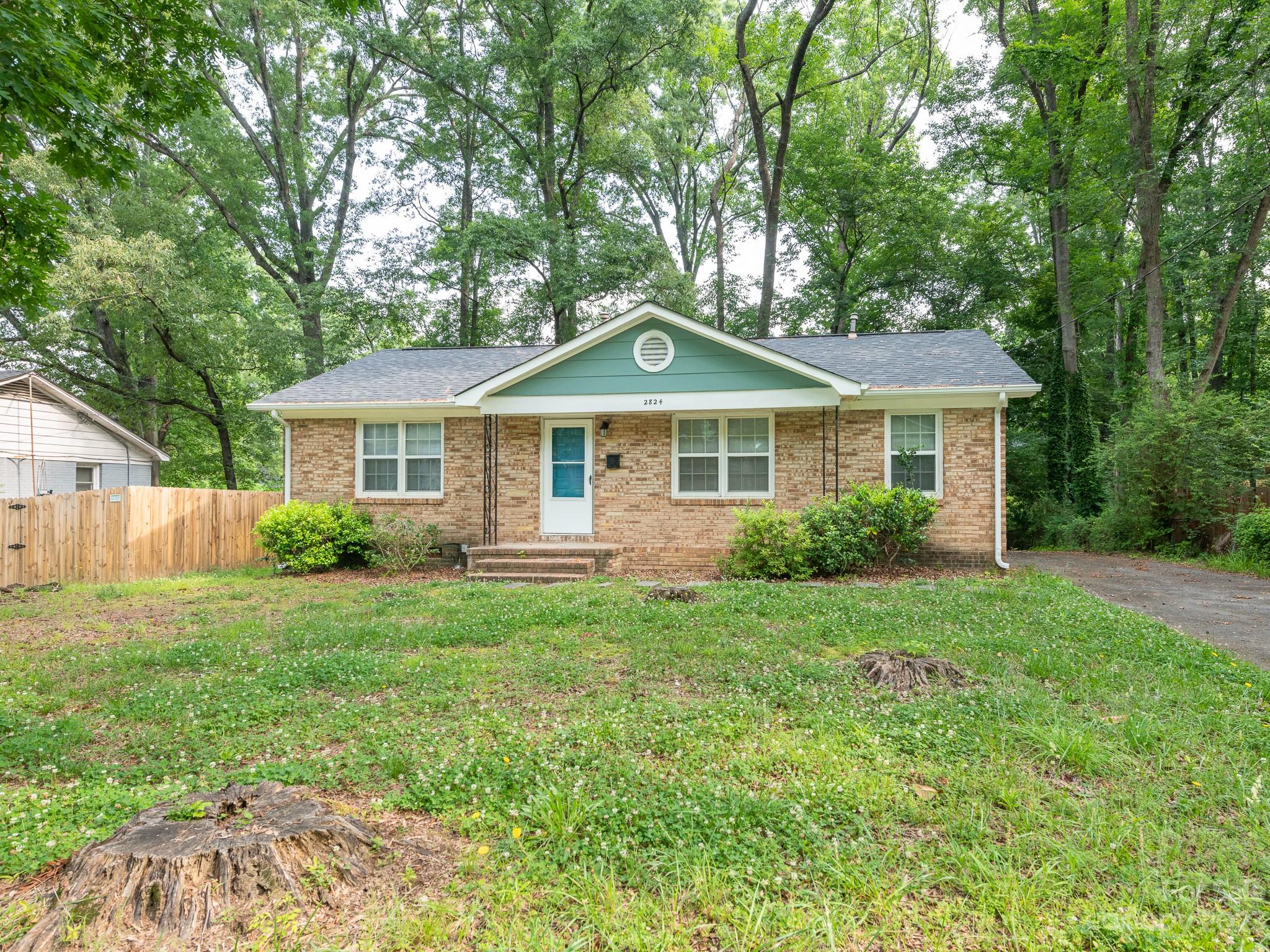 2824 Fordwood Drive Charlotte, NC 28208 - Photo 25 of 33 a front view of a house with a yard