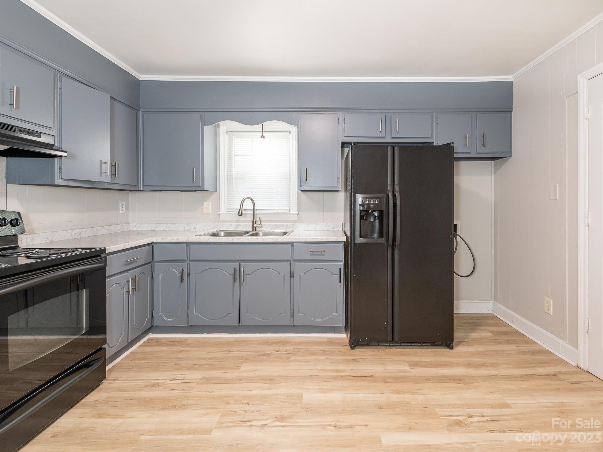 2824 Fordwood Drive Charlotte, NC 28208 - Photo 27 of 33 a kitchen with a refrigerator sink and cabinets