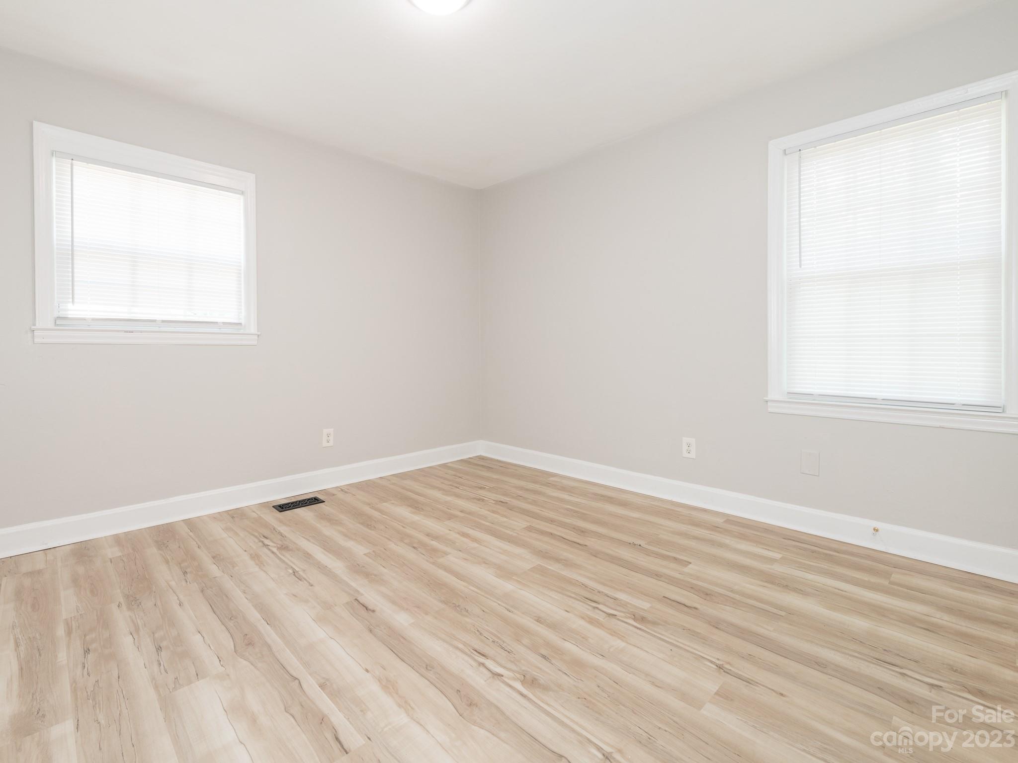 2824 Fordwood Drive Charlotte, NC 28208 - Photo 7 of 33 a view of an empty room with wooden floor and a window